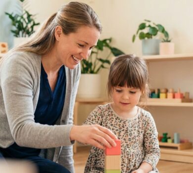 caregiver and child playing with blocks