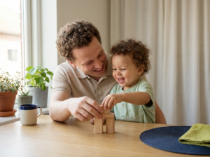 Parent and toddler playing with blocks in a sunny kitchen